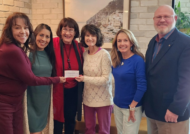 Community supporters presenting a donation